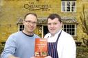 Richard Shore (left) and William Guthrie outside The Churchill Arms with a copy of The Michelin Guide 2010. Picture by Linda Butler.