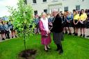TREE PLANTING: Dodderhill School founder Jean Davidson with headmistress Cate Mawston and schoolchildren.