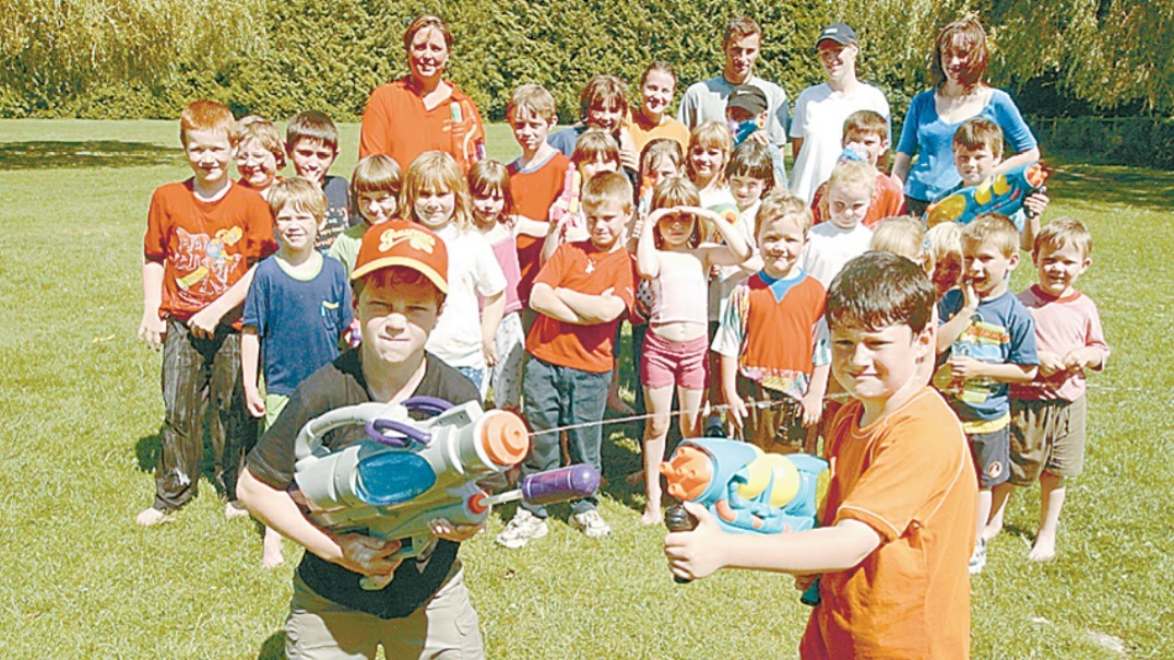 August 2002 and youngsters had a splashing time with their weekly wet and wild day at Moreton Playspace. James Evans and Liam Peach take their turn on the water pistols 