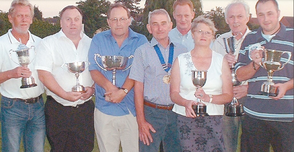 Evesham and District Skittles League prize winners clutching their trophies in August 2006, from left: Nigel Guscott, Kevin Newbury, Richard Ford, Brian Jinks (league president), Graeme Hartwell (league chairman), Rachel Walker, Bill Quinn and Dan Ford 