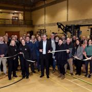 Staff and members at Moreton Sports Centre celebrate the unveiling of the new equipment