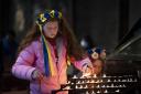 Girl lights candles following Russian invasion of Ukraine. Photo: PA.