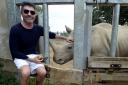 Simon Cowell at Cotswold Wildlife Park with the gold-encrusted rhino dropping he started the bidding on (Image: Paul Nicholls Photography)