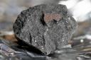 A fragment of the Winchcombe meteorite, which experts believe holds key information about the origins of life on earth. Credit: PA