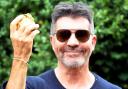 Simon Cowell bids thousands for 24-karat gold-leaf Rhino poo at charity auction