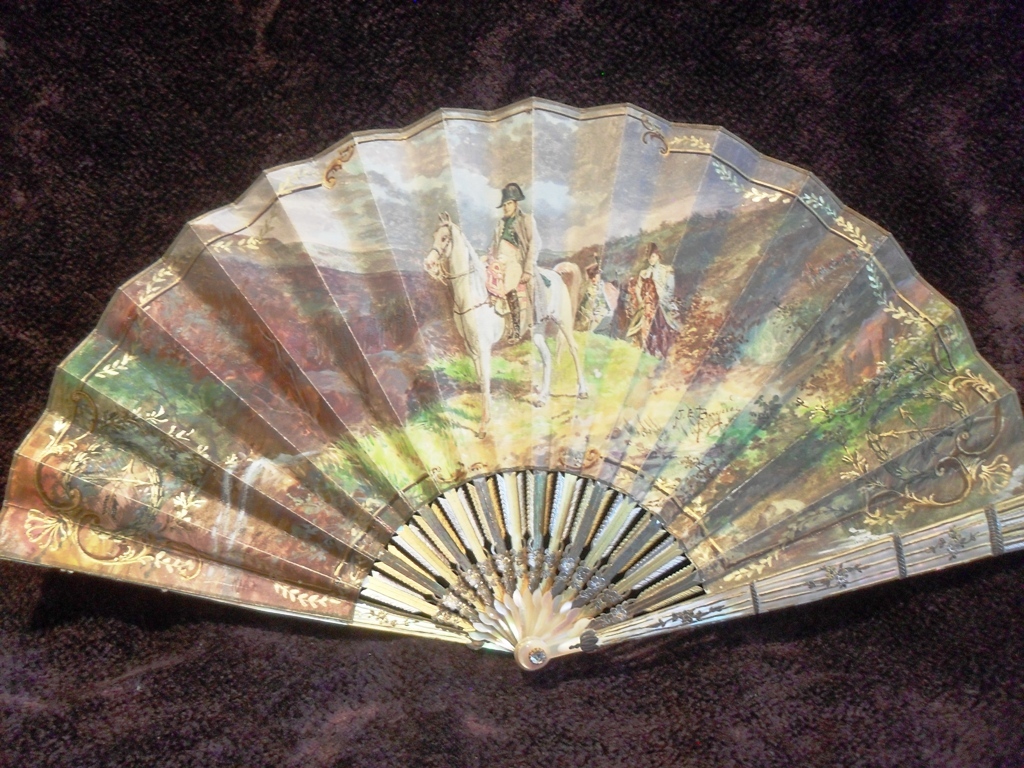 A 19th-century mother of pearl fan showing the Emperor Napoleon Bonaparte in classical pose 