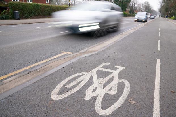 Traffic passes a cycle lane in Birmingham