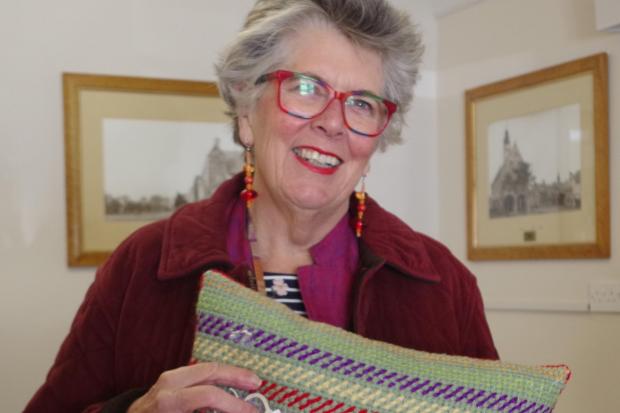 During her visit to Moreton Country Market, Prue Leith received a cushion embroidered by local resident Daphne Carss