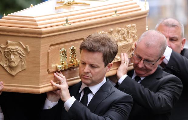 Cotswold Journal: Declan carries his brother's coffin. Picture: NORTH NEWS