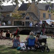 Many tourists come to Bourton to bathe in the River Windrush