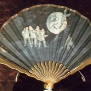A painted fan by Van Garden dating from circa 1900 showing Pierrots pulling a tooth from the mouth of the Man in the Moon
