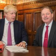 Sir Geoffrey Clifton-Brown (L) has called for PM Boris Johnson (R) to come back in the new year 