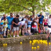 The North Cotswold Rotary's annual rubber duck race day in Bourton raised almost £2,000 for charity