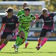 Forest Green Rovers forward Josh March (28) under pressure from Exeter City defender Alex Hartridge (5) and Exeter City defender Jack Sparkes (3) during the EFL Sky Bet League 1 match between Forest Green Rovers and Exeter City at the The Bolt New Lawn,