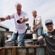 Jeremy Clarkson and Kaleb Cooper hand out Hawkstone beers to Oxfordshire's Alpine F1 team following a social media challenge