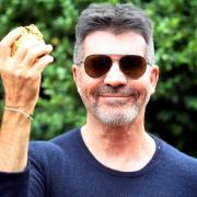 Simon Cowell bids thousands for 24-karat gold-leaf Rhino poo at charity auction