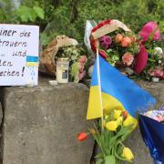 Flowers and a small Ukrainian flag were left at the scene (dpa via AP)