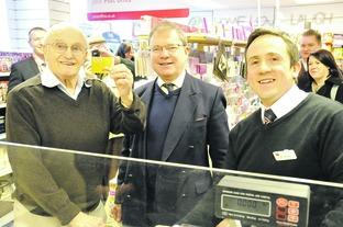Cecil Minchin, aged 94, buying the first book of stamps from the newly refurbished Bourton Post Office, with Geoffery Clifton-Brown MP and Post Office Manager Gary Kirkman.