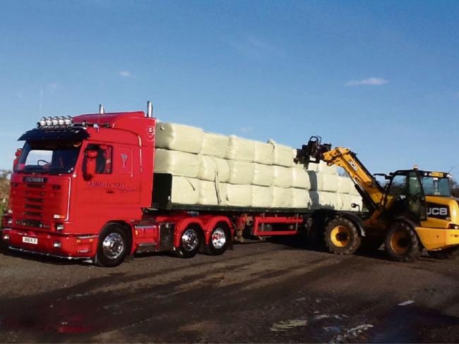 The bales of hay being loaded for delivery to the Somerset Levels