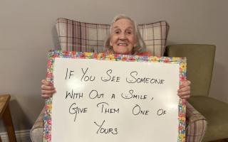 Southerndown resident Sheila Radcliffe pictured holding an inspiring quote for Mental Health Awareness Week